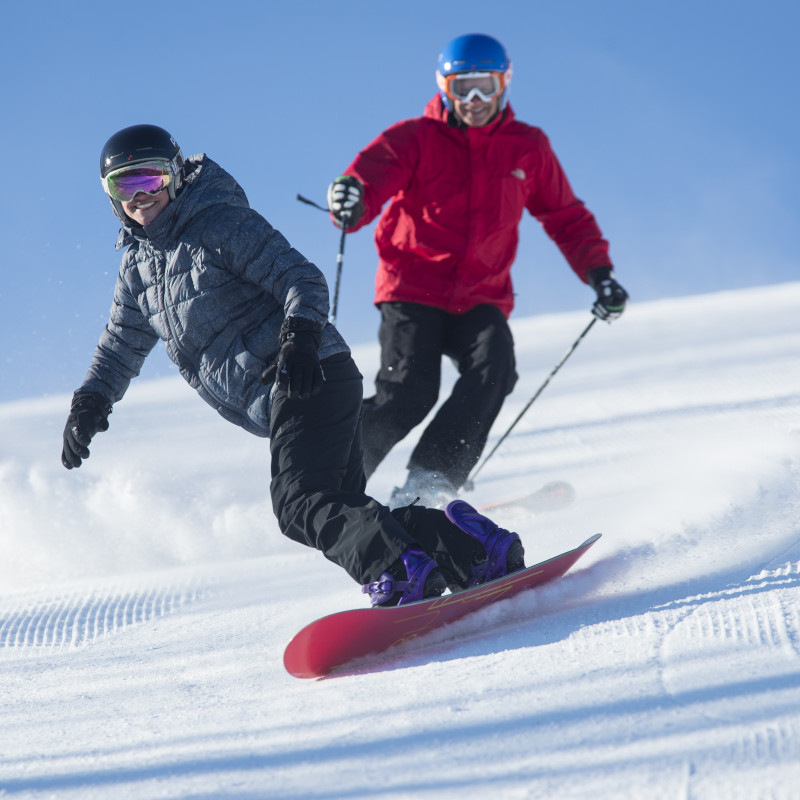Skier and snowboarder on the slopes
