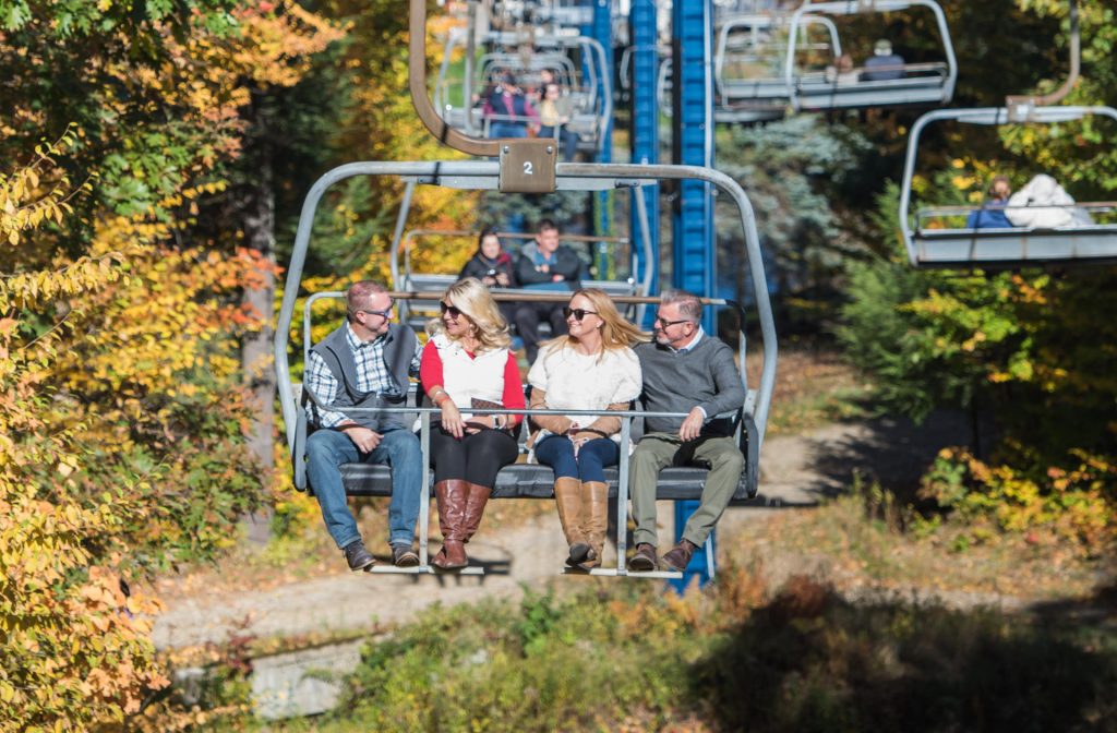 Group on chairlift in the fall